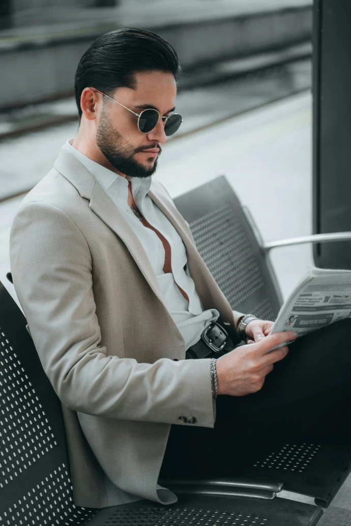 a man in a suit and tie sitting on a bench